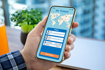 man hand hold phone with application searching air tickets