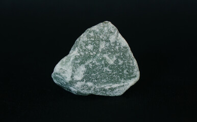 Raw specimen of green Aventurine stone isolated on black background. Lucky Opportunity Prosperity stone.