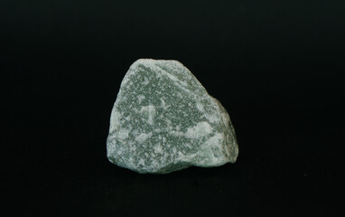 Raw specimen of green Aventurine stone isolated on black background. Lucky Opportunity Prosperity stone.