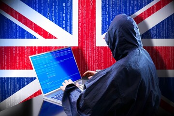 Anonymous hooded hacker, flag of United Kingdom, binary code - cyber attack concept