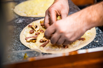 hand of chef baker making pizza at kitchen. The process of making pizza. cooking italian pizza