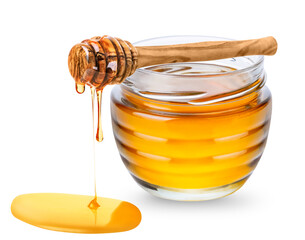 Glass jar with honey and wooden honey dipper with honey drop isolated on white background
