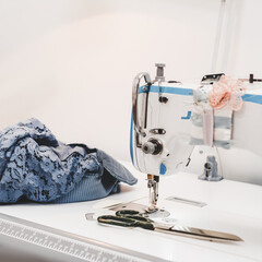 Modern sewing machine on designer work place in modern atelier