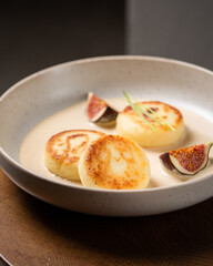 Cottage cheese pancakes with caramel cream sauce and fresh figs ( syrniki )