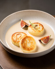 Cottage cheese pancakes with caramel cream sauce and fresh figs ( syrniki )