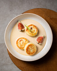 Cottage cheese pancakes with caramel cream sauce and fresh figs ( syrniki )