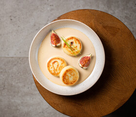 Cottage cheese pancakes with caramel cream sauce and fresh figs ( syrniki )