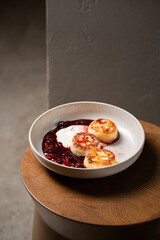 Cottage cheese pancakes, cherry sauce and yogurt ( syrniki )
