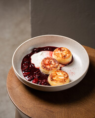 Cottage cheese pancakes, cherry sauce and yogurt ( syrniki )