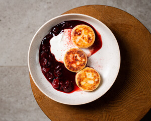 Cottage cheese pancakes, cherry sauce and yogurt ( syrniki )