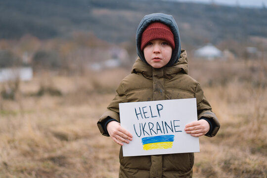Help Ukraine. War of Russia against Ukraine. Ukrainian Crying boy asks to stop the war in Ukraine. Child with message Stop War.