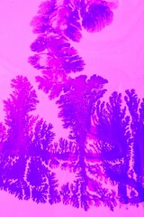 Lilac-pink marble background. Acrylic paint flows freely and creates an interesting pattern. Background for the cover of a laptop, laptop, book.