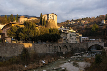 Torrente Leno river as it flows through Rovereto in Trentino, NE Italy. It is one of the main tributaries of the Adige river. Castello di Rovereto castle is background centre and Ponte Forbato bridge 
