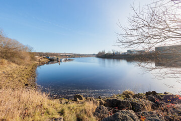 Newcastle UK: 31st Jan 2022: Newburn Riverside at the River Tyne, lovely still calm water on sunny day. A1 motorway bridge in background