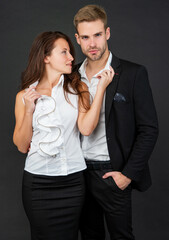 formal couple in love in business look together on black background, leadership