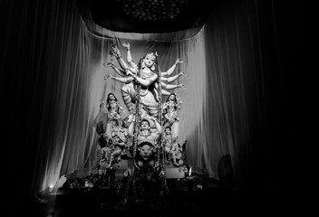 Kolkata, West Bengal, India - 8th October, 2019 : Decorated Durga Puja pandal at night with idol of...