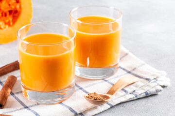 Beverage with pumpkins and milk wooden background. Lactose-free pumpkin milk