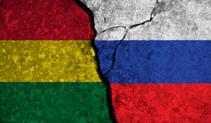 Political relationship between Bolivia and russia. National flags on cracked concrete background