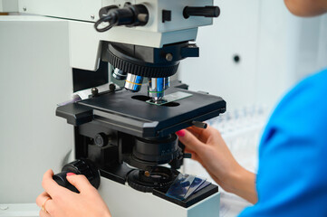 Examination of analyzes using a microscope. Laboratory with microscope