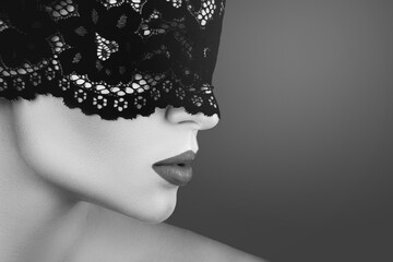 Young beautiful woman wearing black lace blindfold - obrazy, fototapety, plakaty