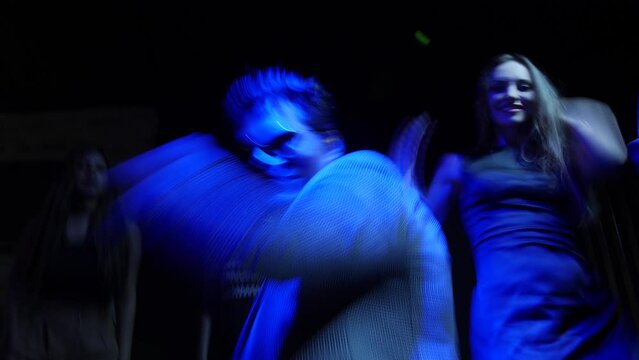 A men dancing with his female friends at a party at Bay 15, Goa.