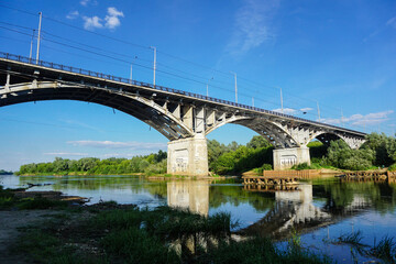 Fototapeta na wymiar The old bridge across Klyazma river in Vladimir city. Sunny summer day with the clear sky.