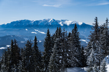 snow covered mountains, viewpoint from Postavaru Mountains to Bucegi, Romania 
