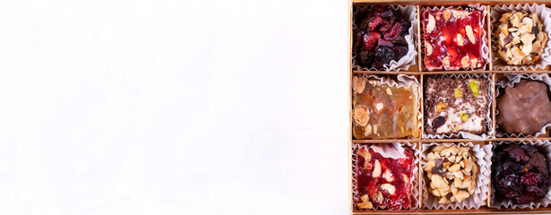 Web banner with Turkish delight sweets in the box. Colorful confectionery variation. Eastern dessert. Mockup with copy space on white background