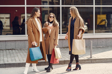 Woman walks outside with shopping bags