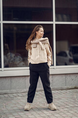 Elegant woman in a brown shirt in a spring city