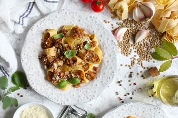 Pappardelle pasta with lentil ragout on light background. Vegan and vegetarian food. Top view.