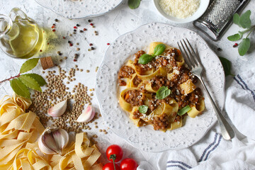 Pappardelle pasta with lentil ragout on light background. Vegan and vegetarian food. Top view.