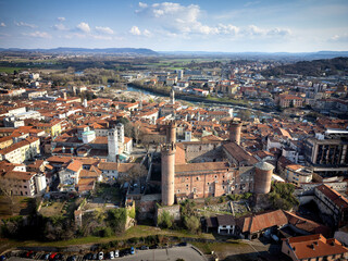 Aerial view of the historic centre with the Castle with its red towers in the foreground. Ivrea,...
