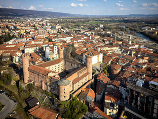 Aerial view of the historic centre with the Castle with its red towers in the foreground. Ivrea, Italy - March 2021 - obrazy, fototapety, plakaty