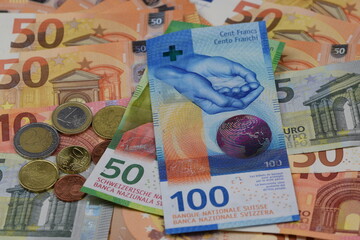 Swiss francs on euro money background, Switzerland money banknotes and european banknotes, francs...