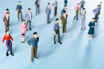 a group of miniature people on a colored surface	
