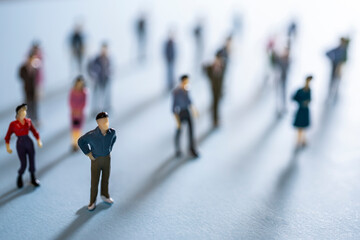 a group of miniature people on a colored surface	