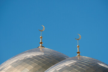 Muslim mosque, dome against a blue sky with clouds. Religious holidays concept.