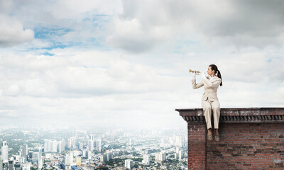 Elegant young woman playing trumpet