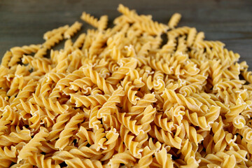 Pile of Uncooked Whole Wheat Fusilli Pasta for the Concept of Wellness