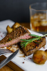 Fresh grilled meat.Beef steak medium rare with rosemary brunch and mashrooms on wooden cutting board