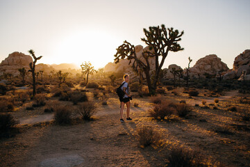 Woman walking in desert with Joshua trees