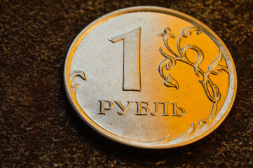 a Russian one ruble coin lies on a dark metal background. close-up