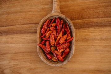 Red cayenne pepper. Red chili on wooden spoon. 