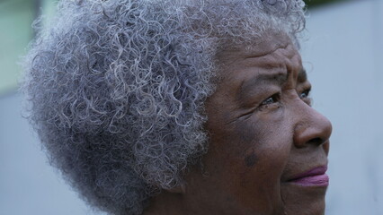 A meditative senior woman portrait face closeup in contemplation