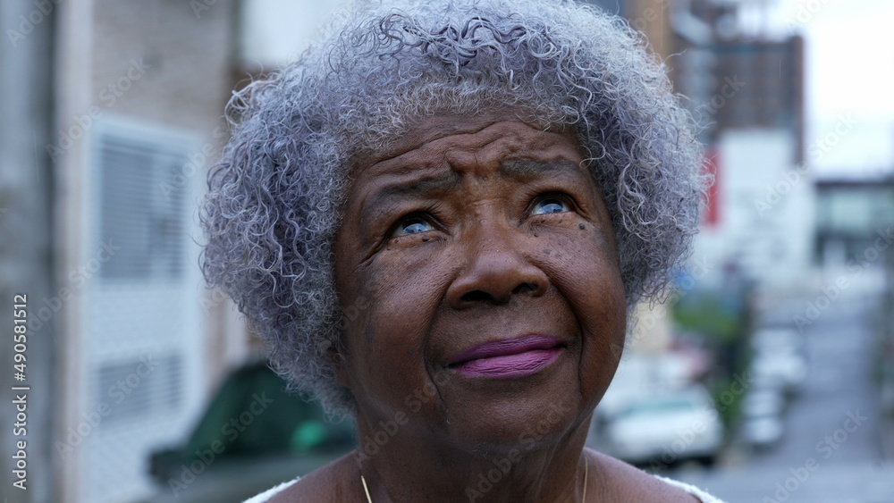 Sticker A contemplative senior black woman looking up at sky an African person eyes looks up