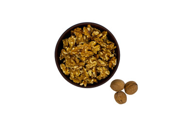 Peeled walnuts in brown plate