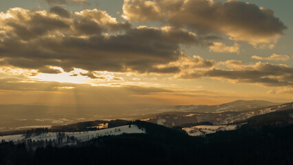 Winter forest, sky with clouds at sunset