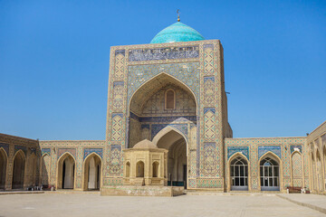Fototapeta na wymiar In the courtyard of the Kalan Mosque in Bukhara, Uzbekistan. Structure was built in 1515. It is part of the Poi-Kalyan architectural ensemble