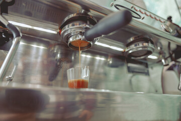 Close-up photo of dripping coffee oils into cup